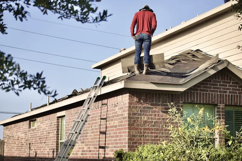 Professional roofer working on a residential roof in Overland Park